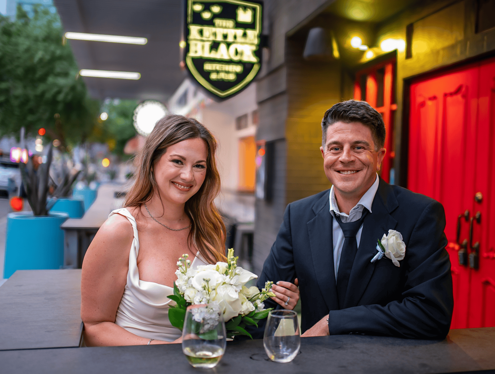A joyful wedding celebration captured at a stylish venue with vibrant decor.