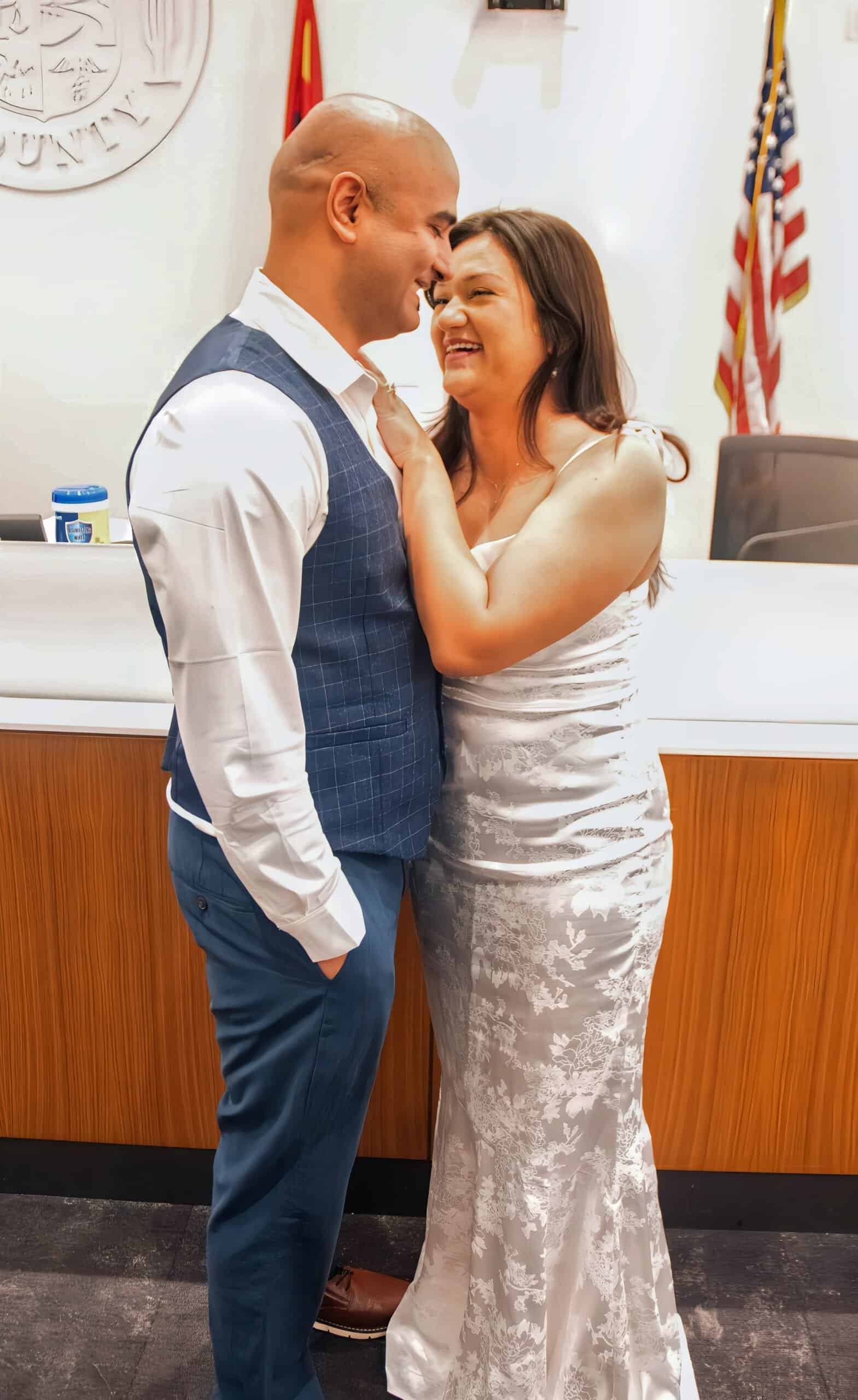 Happy bride and groom smiling and embracing during their wedding celebration.