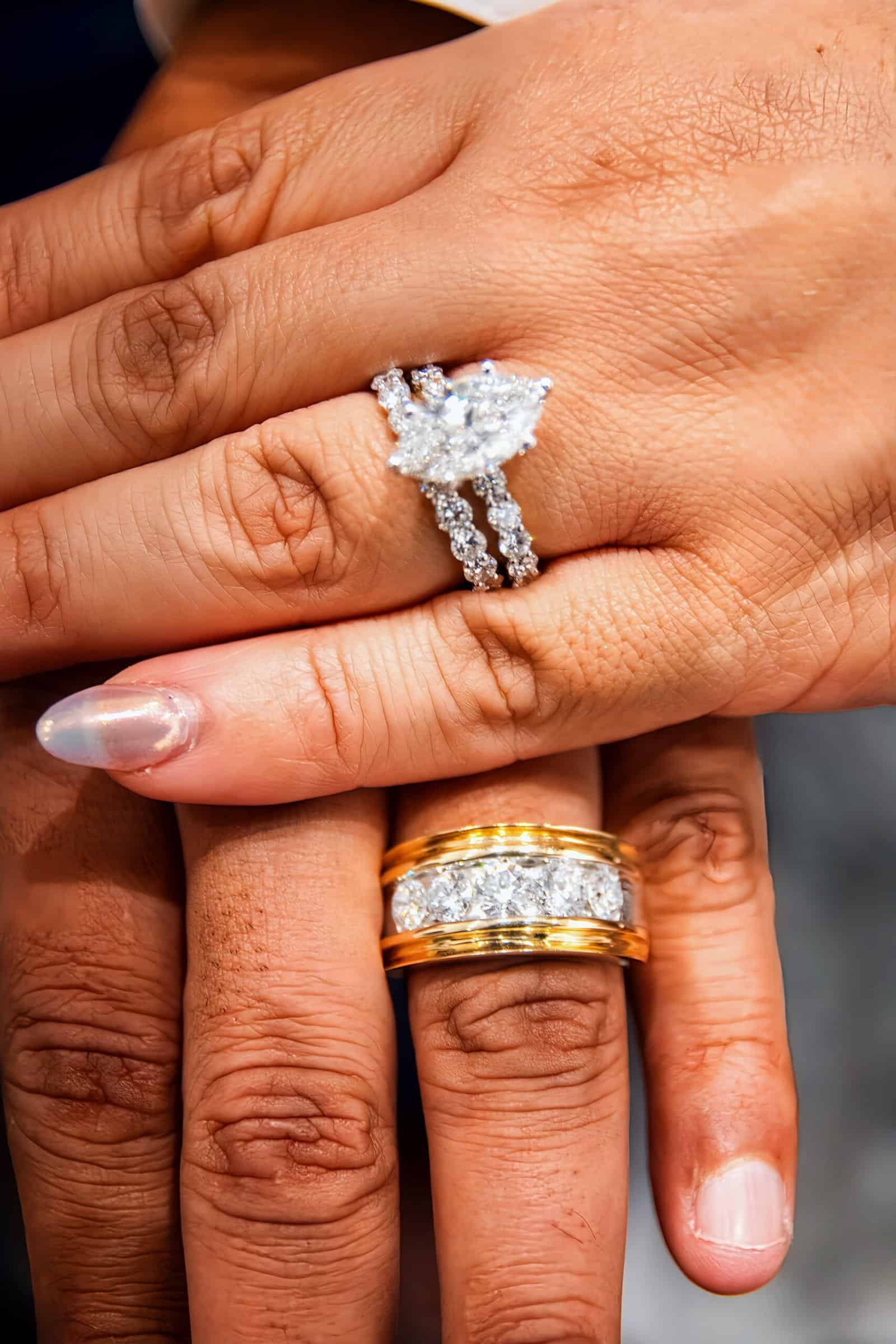 Close-up of hands with wedding rings, highlighting love and celebration.