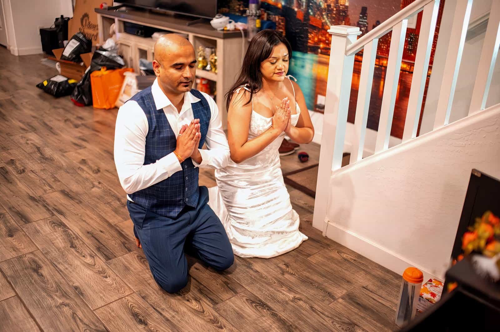 Intimate moment of prayer and gratitude during a special occasion with loved ones.