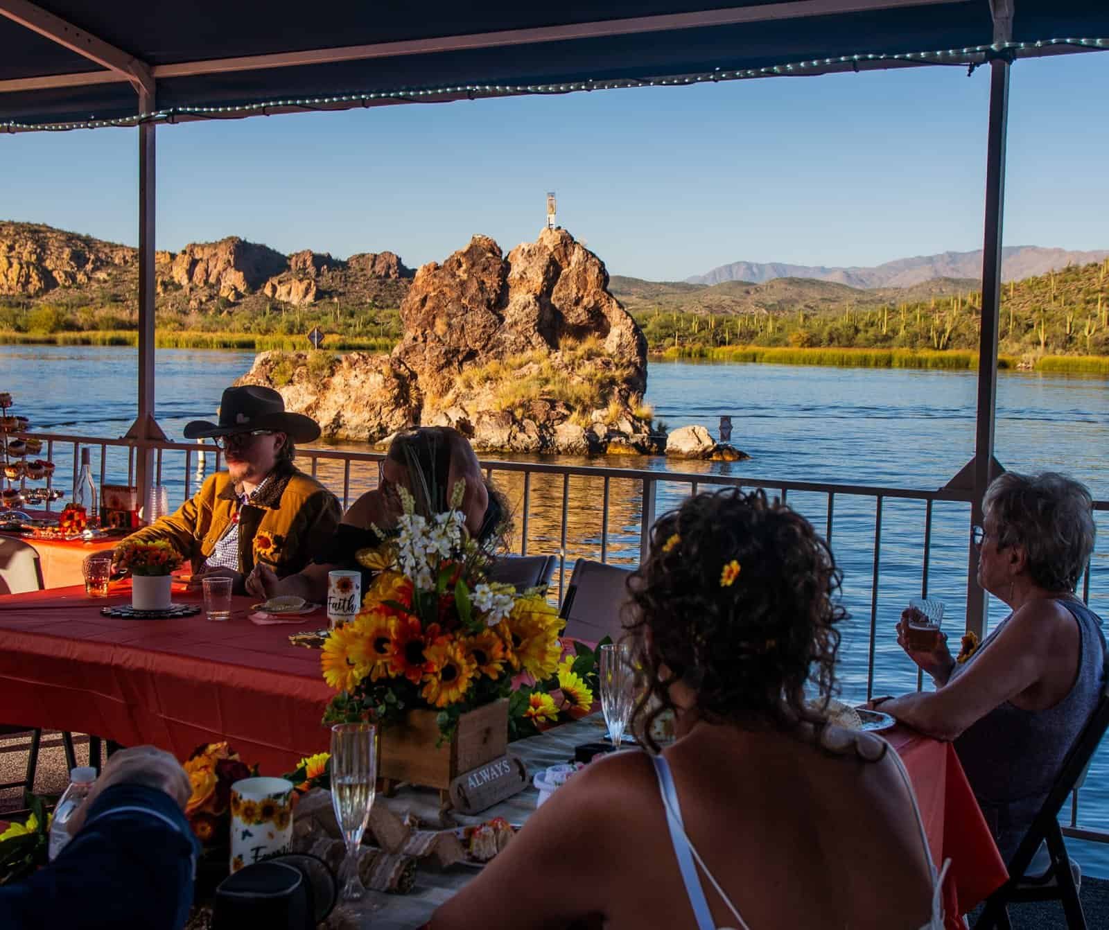 Guests enjoying a special moment during a lakeside event with stunning natural surroundings.