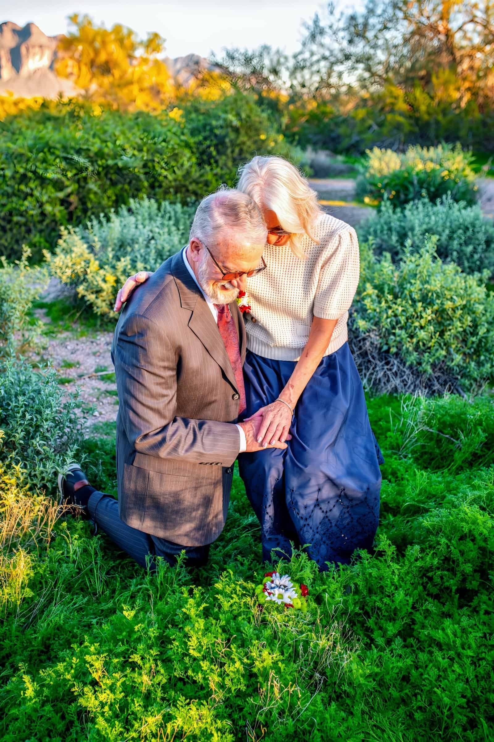 Beautiful elderly couple sharing a tender moment in a vibrant garden setting, emphasizing love and lifelong companionship.