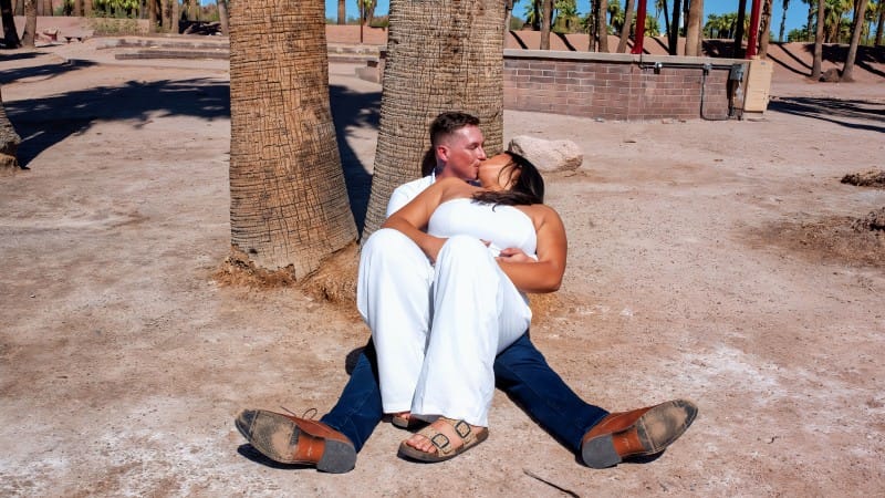 Couple Relaxing Under Palm Trees