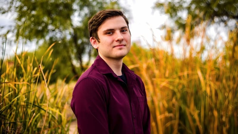 Young Man in Field for Wedding Video
