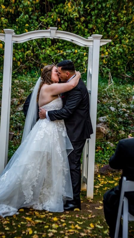Wedding Kiss Under Arch in Phoenix