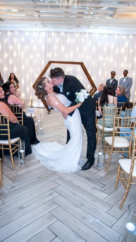 Wedding Couple Kissing Under Decor