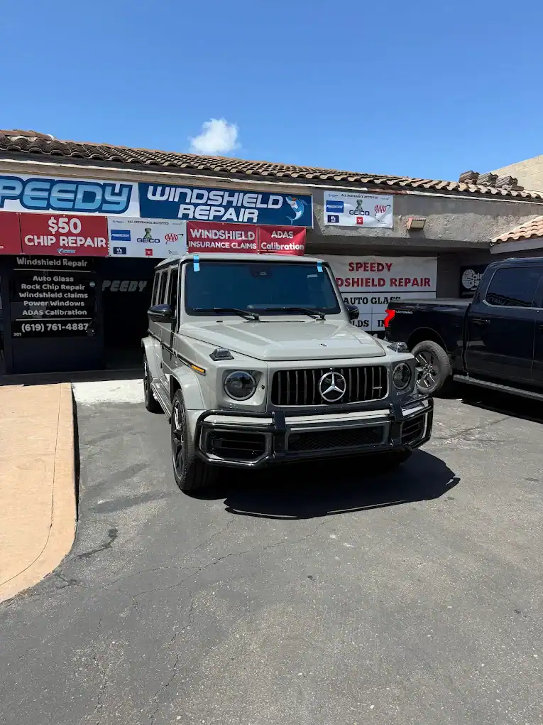 Mercedes G-Class SUV parked at Speedy Windshield Repair shop in San Diego.