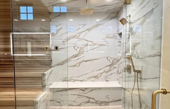 Stanton and Company custom glass-enclosed wet area that combines a walk-in shower and built-in sauna