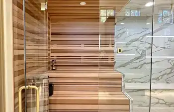 Stanton and Company custom glass-enclosed wet area that combines a walk-in shower and built-in sauna