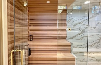 Stanton and Company custom glass-enclosed wet area that combines a walk-in shower and built-in sauna