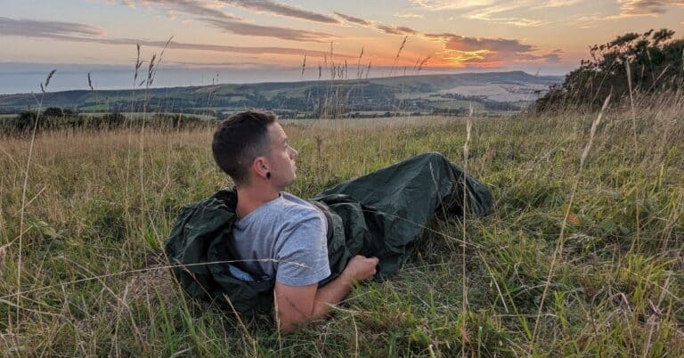 Settling in a bivvy bag for a night of wild camping on the South Downs.