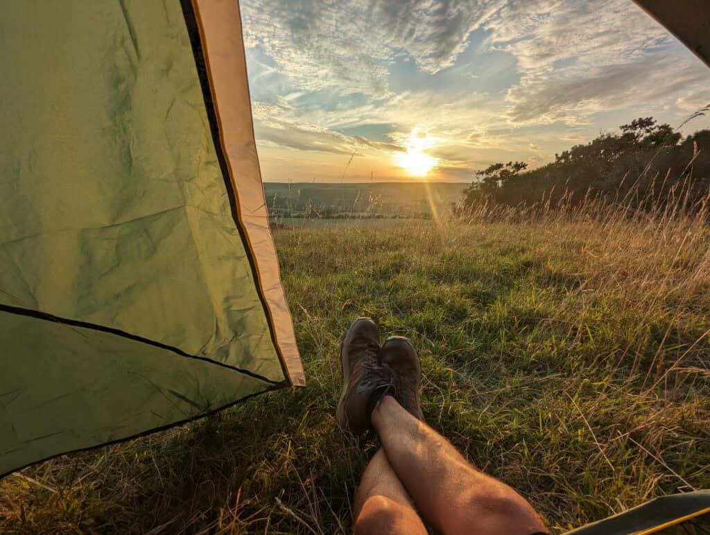 Wild Camping Equipment: Essential Kit List for 2025 1 Watching the sunset from inside my tent