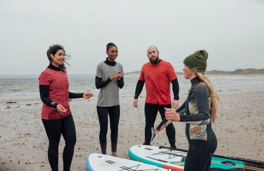 Instructor teaching beginners how to paddle board