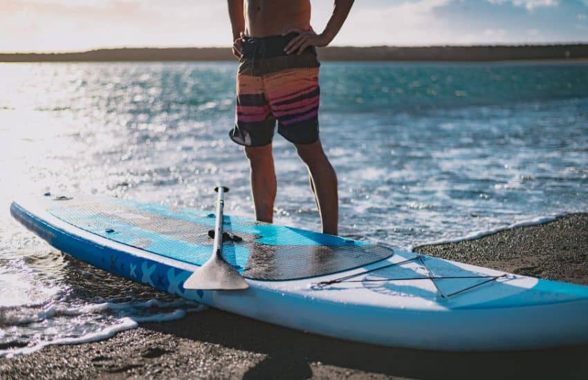 Man read to launch with his SUP and paddle.