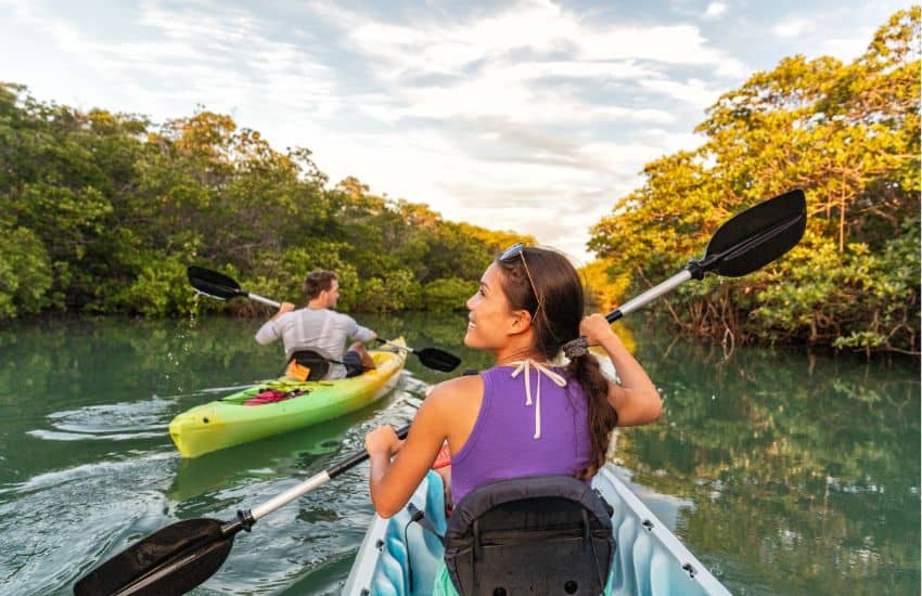 Canoe vs kayak: two people paddling in kayaks