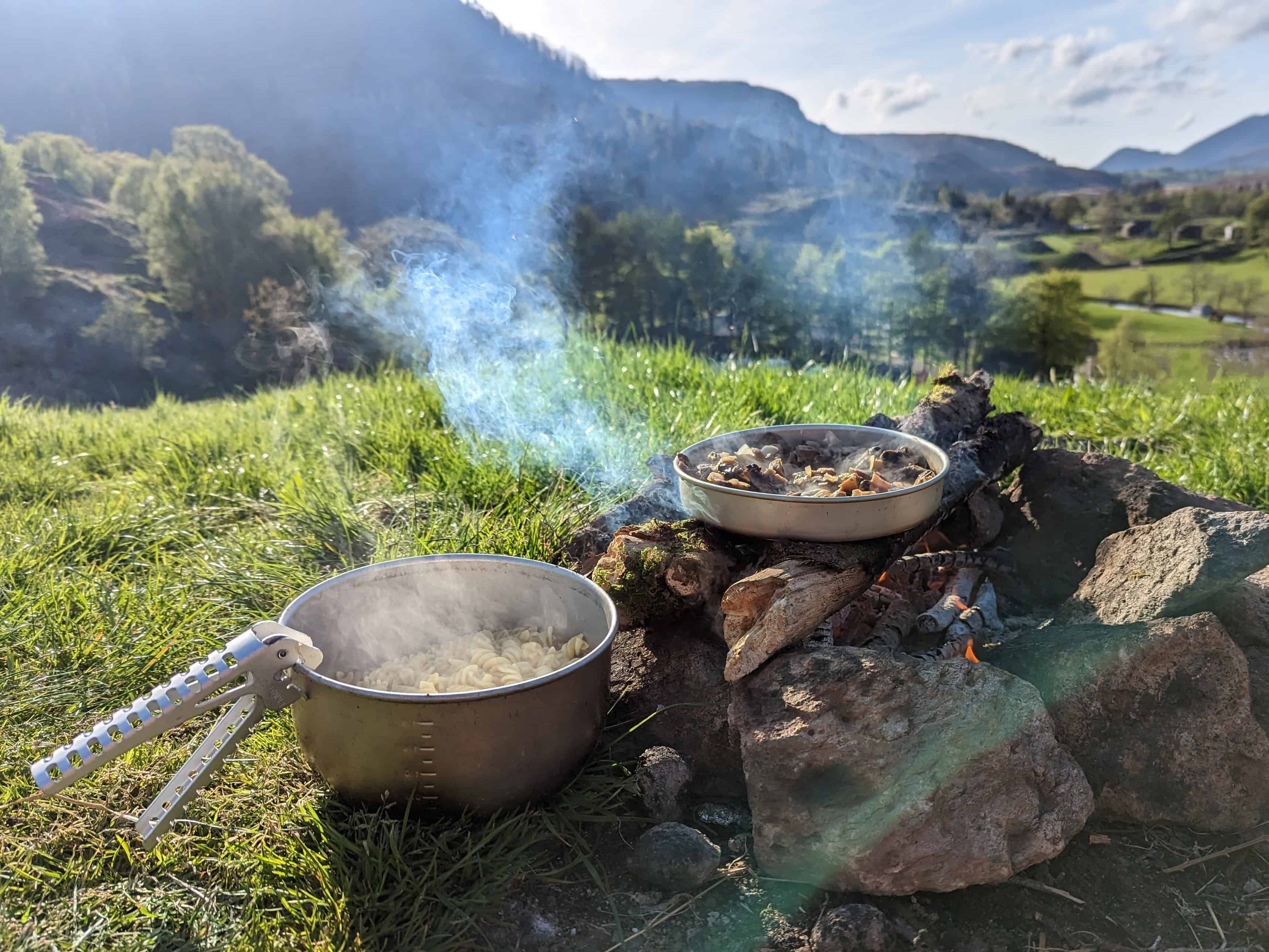 Wild Camping Equipment: Essential Kit List for 2025 7 Cooking mushrooms and pasta on a campfire