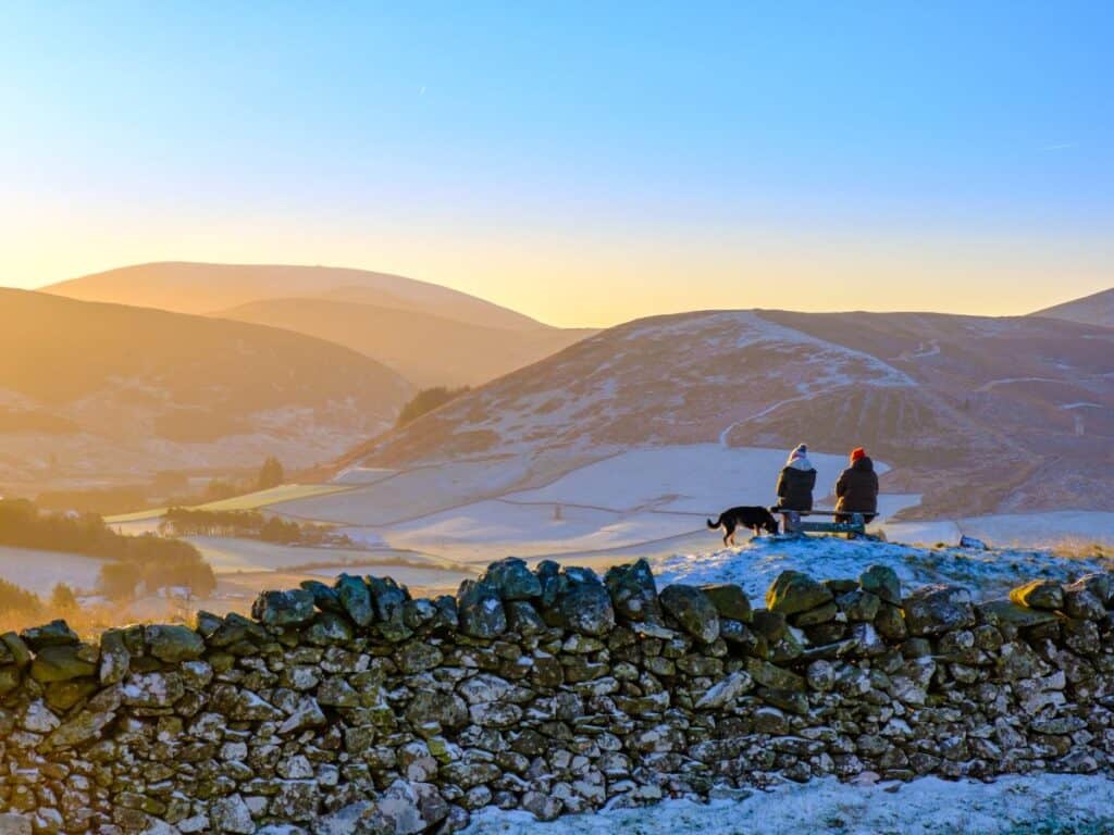 10 Best Places for Wild Camping Scotland (2024) 15 Hikers resting on a bench