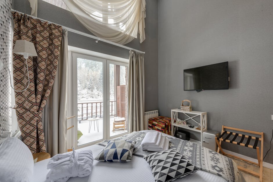Hytteværelse med balkon, store vinduer og komfortabel indretning. Perfekt til afslapning og naturopl.