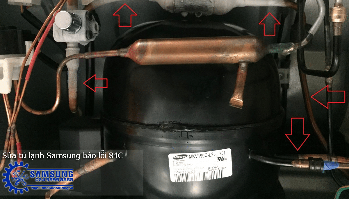 Copper refrigeration pipes and compressor components inside Samsung side-by-side refrigerator showing repair work, with red arrows pointing at key parts in the cooling system.
