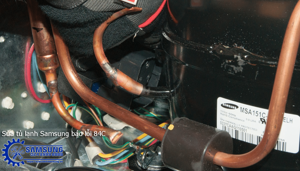 Copper refrigeration pipes inside Samsung side-by-side refrigerator for repair.