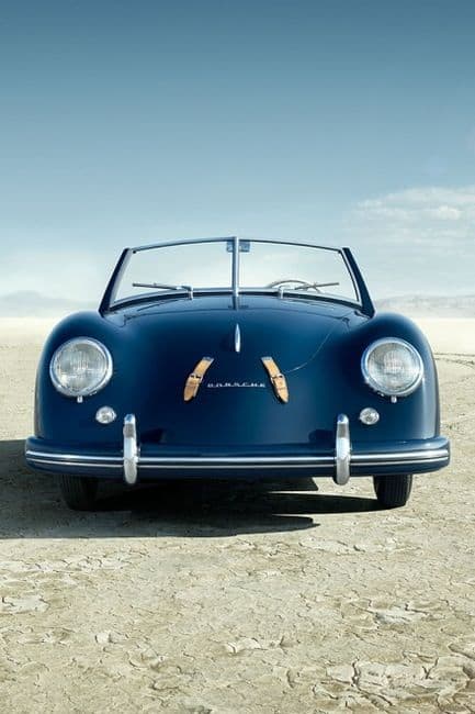 A classic blue convertible sports car, viewed from the front, parked on a dry, cracked desert landscape under a clear sky. Suite Web Design's Elevate WordPress Website Package for small business based on the Gold Coast.