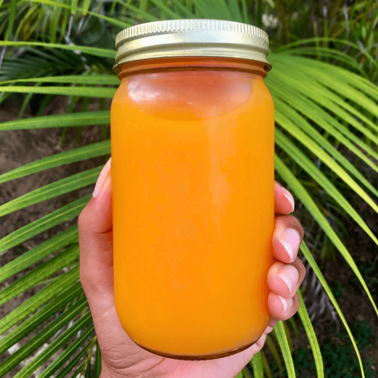 an orange an lemon juice that is organic in front of a leaf