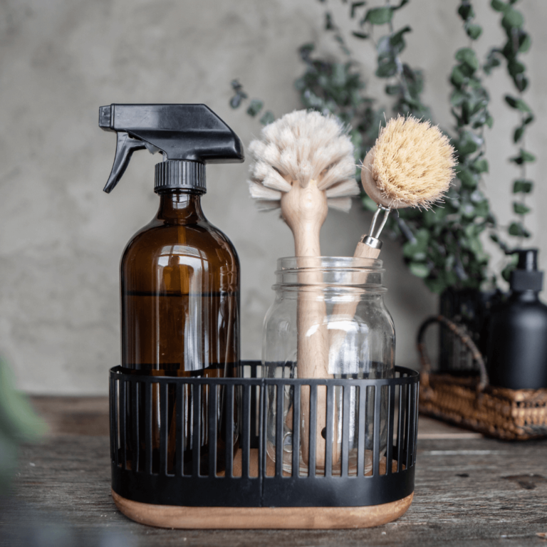 An amber spray bottle, and brushes for a non toxic cleaning routine