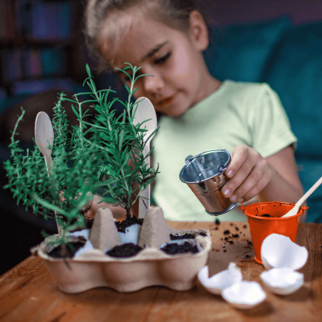 A kid planting seeds using an old egg carton as an eco friendly hands on activity