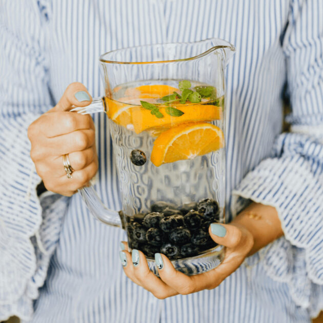 pitcher of water, fruit and herbs