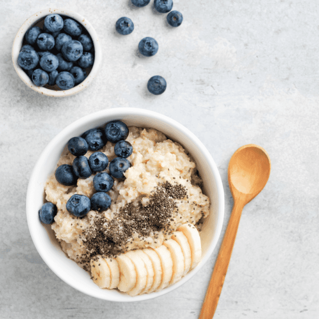 A bowl of protein packed oatmeal with blueberries and bananas and chia seeds