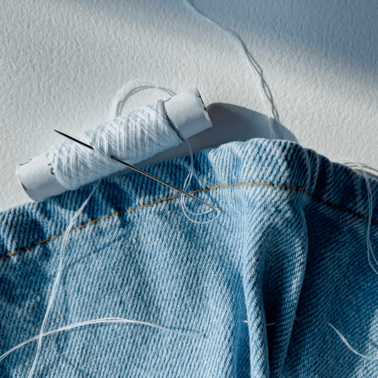 jeans and sewing needle to repair clothes
