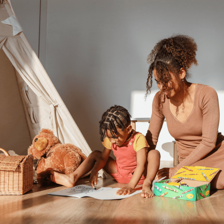 a black mom and baby playing with eco friendly baby products