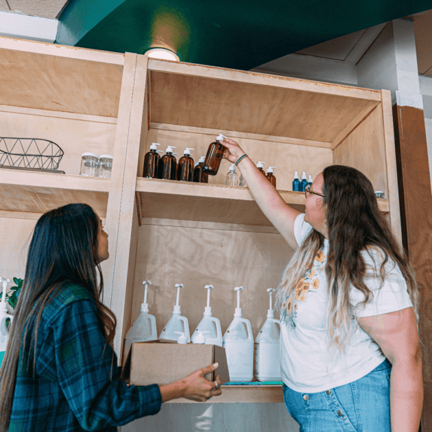 two women at a zero waste store getting eco friendly cleaning supplies for their yoga studio