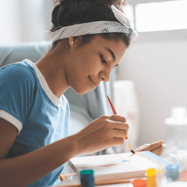 a teen girl painting as her self care practice
