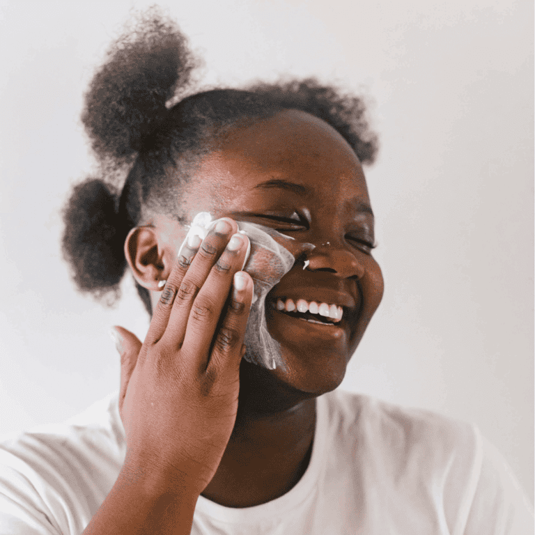 a woman applying sustainable skincare products on her face
