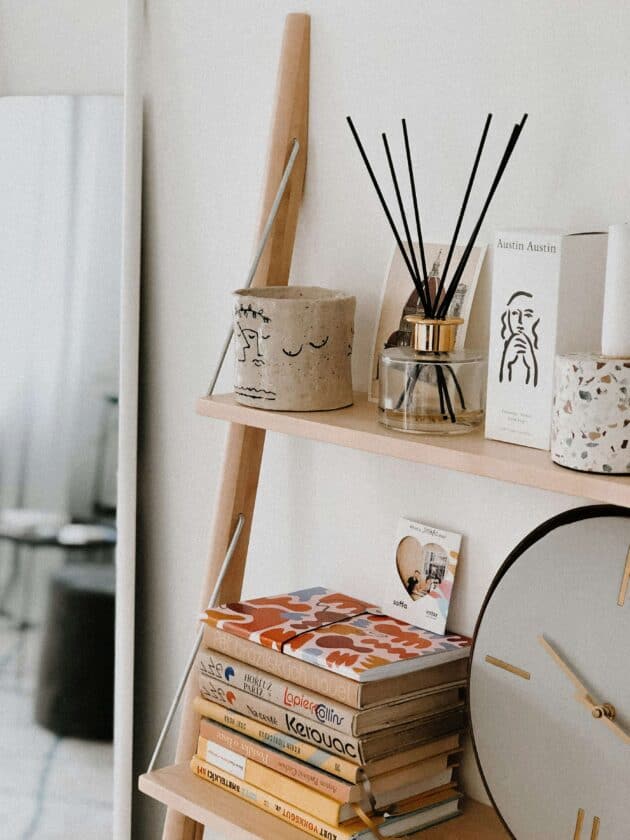 small bookshelf in bedroom with some books and other bookshelf decor