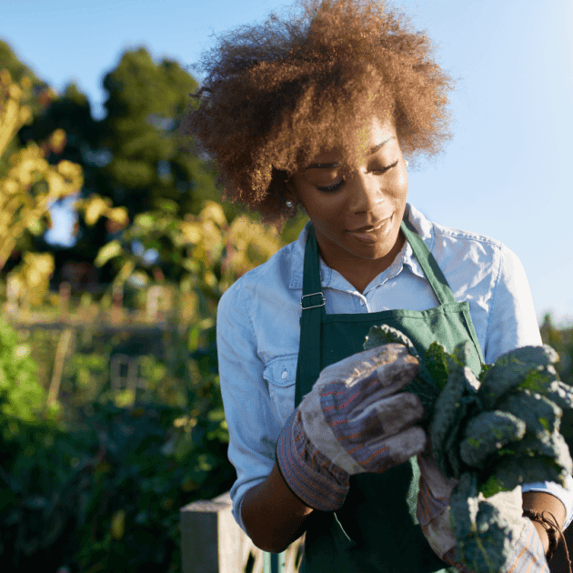 a woman growing kale for her homemade juices