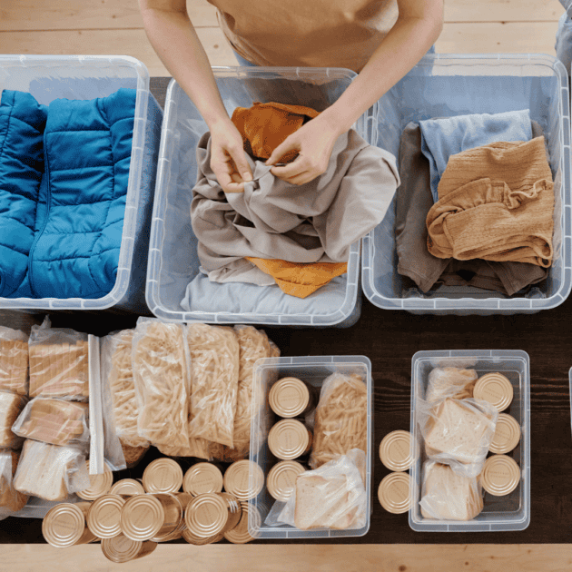 a woman organizing her clothes for camping storage