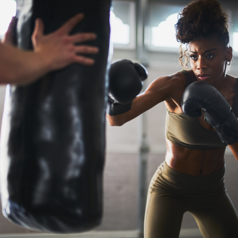 a woman kickboxing in her home gym