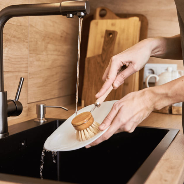 a person washing dishes with eco friendly products