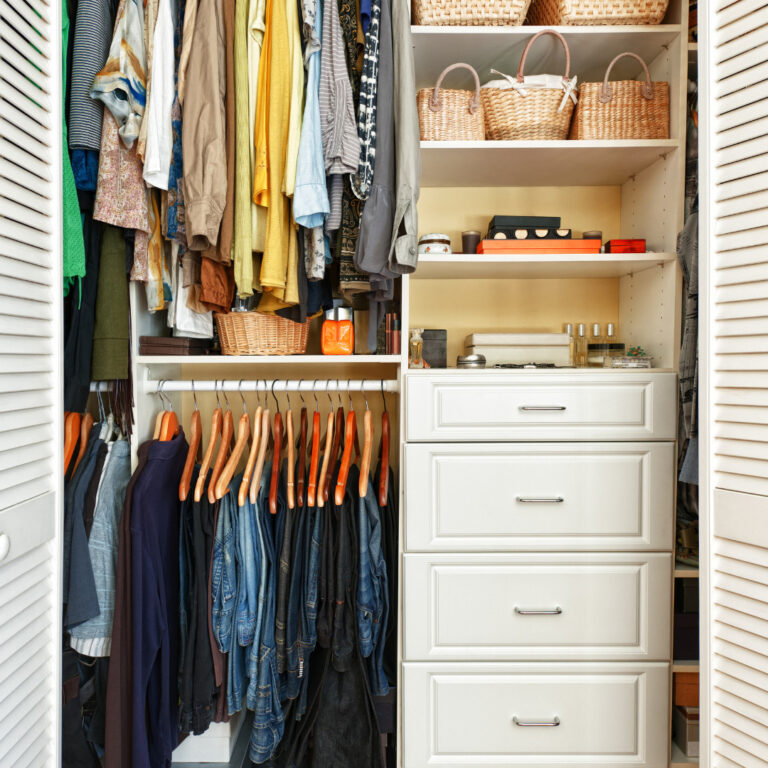 a walk-in closet in a small bedroom