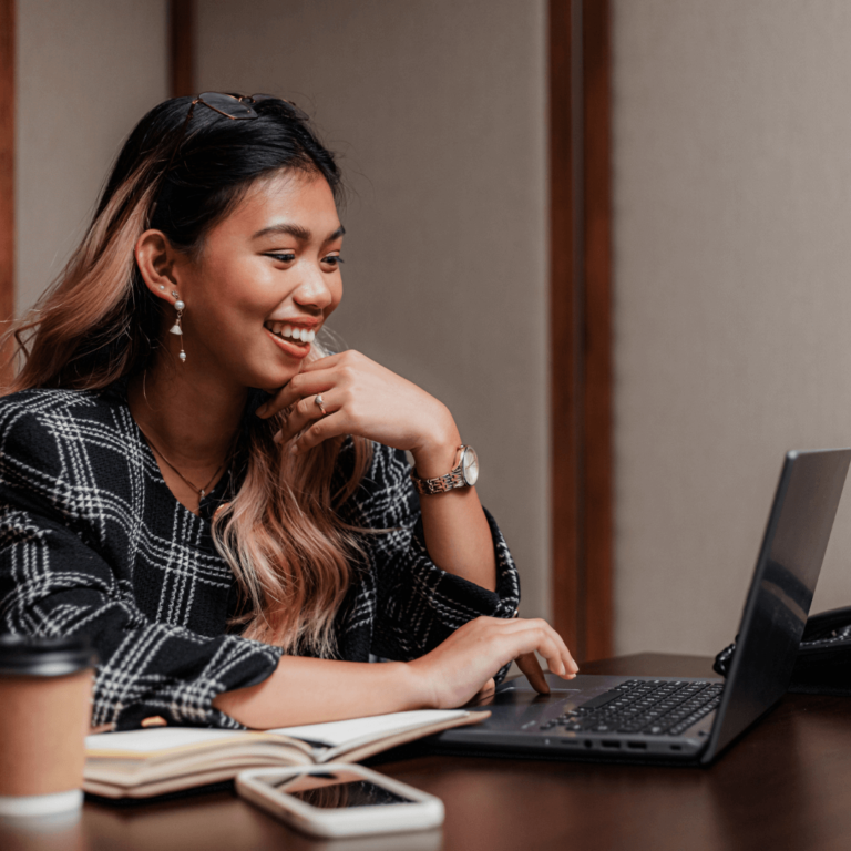 a woman working hard on her goals. She is working on her computer.