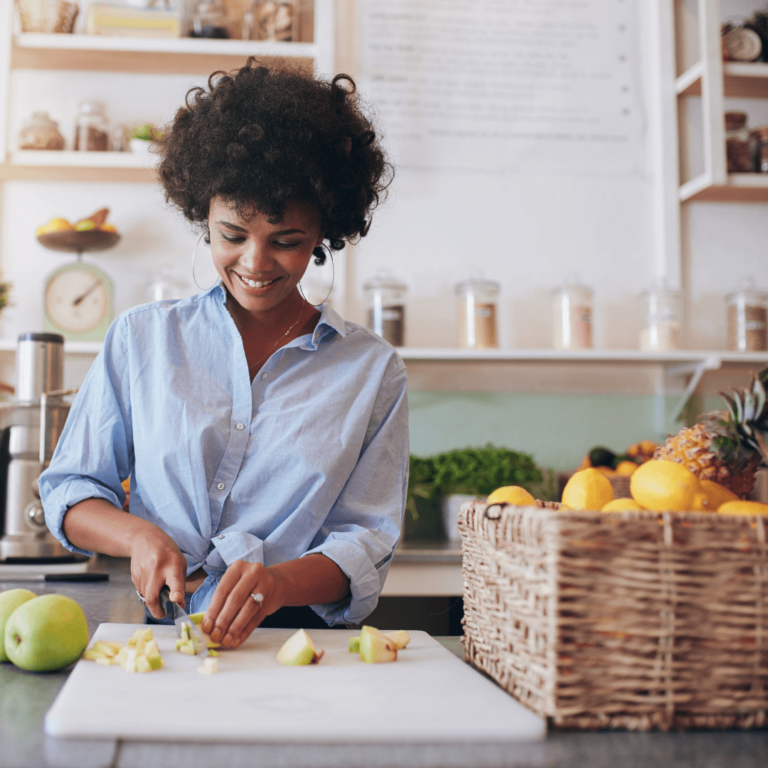 a woman making fresh pressed juice in her kitchen and saving the food scraps for zero waste DIY projects and baking