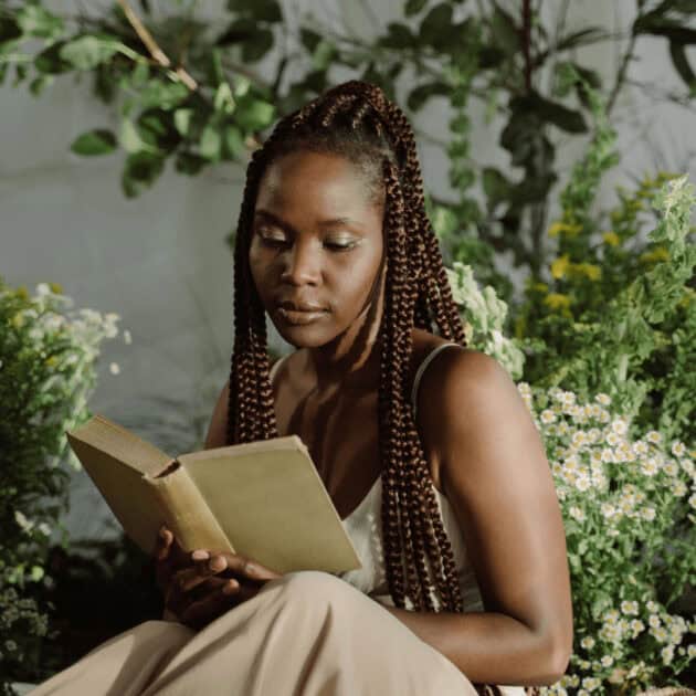 a woman reading a non fiction book for the 75 hard challenge