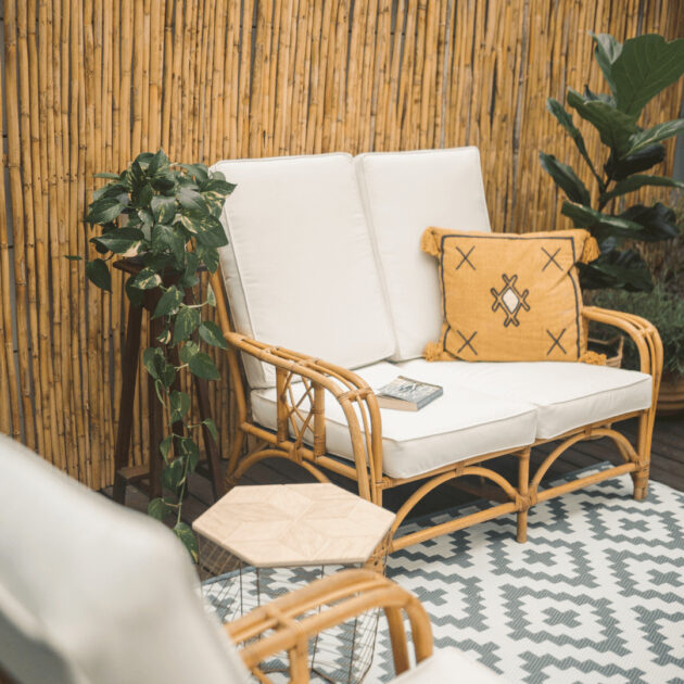 a DIY bamboo fence privacy screen near a backyard fire pit area