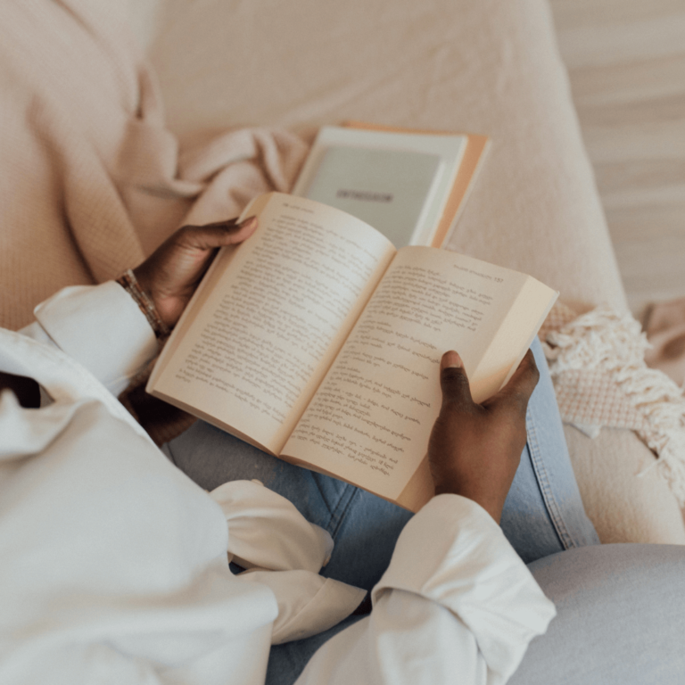 a woman reading a book as a relaxing cozy hobby