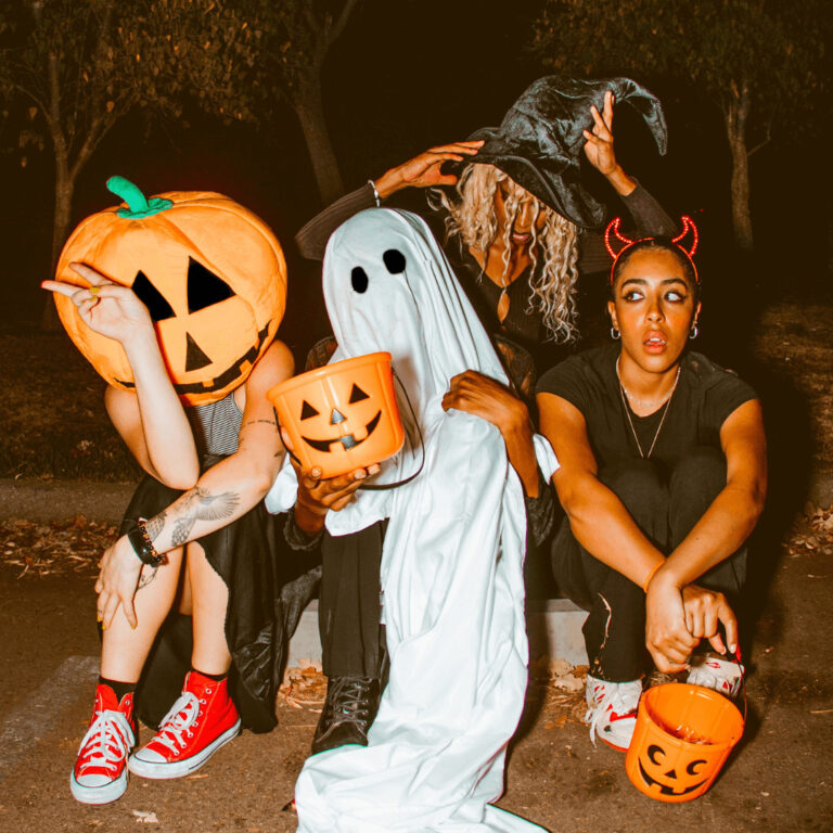 A group of friends wearing thrifted Halloween costumes