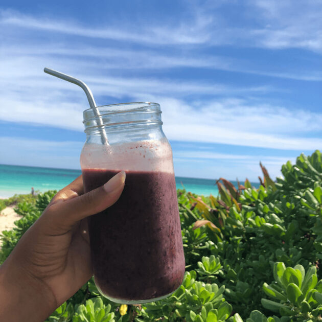 a smoothie at the beach for holistic wellness and taking good care of your curly hair