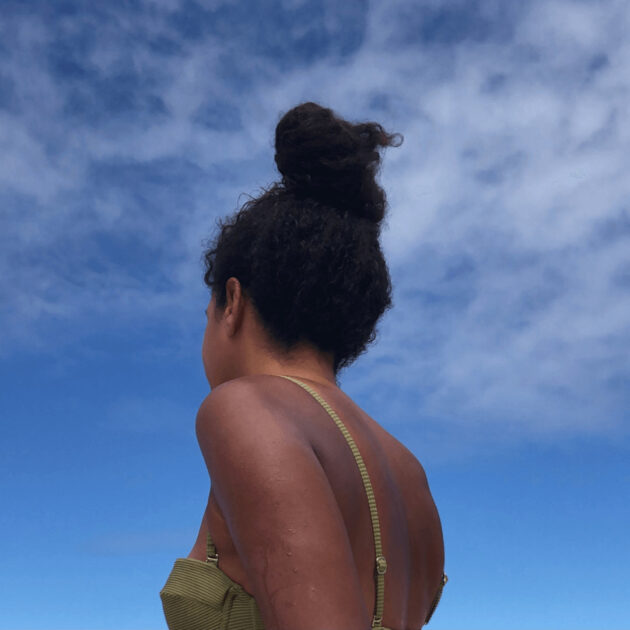 Black woman with natural hair in bun at beach