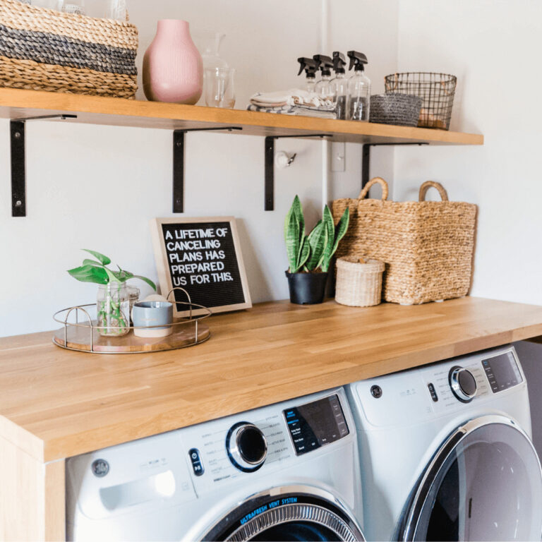 an organized laundry room in a small apartment